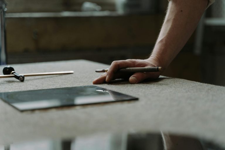 a person holding a glass cutter